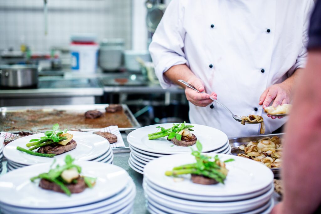 A chef preparing multiple plates of food