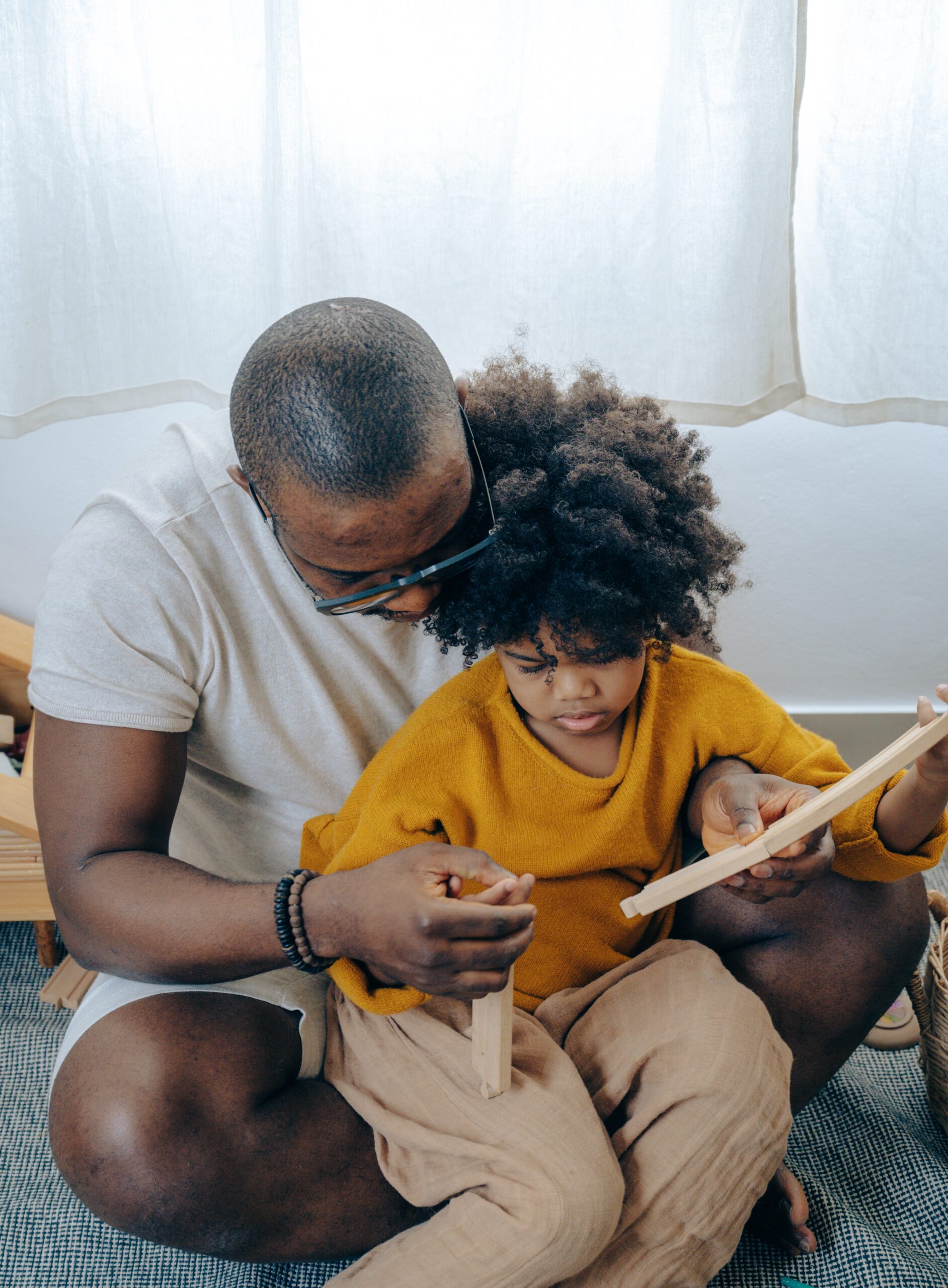Father with child on his lap and reading from a book